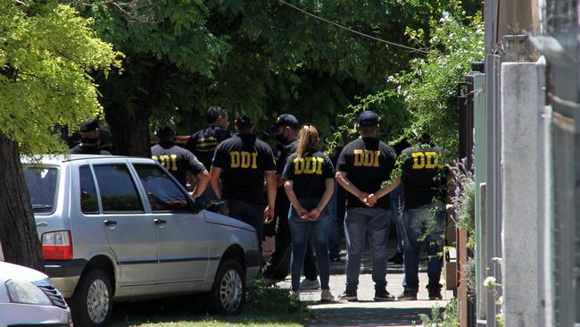 Police stand outside the home of late Argentine football legend Diego Maradona's doctor, Leopoldo Luque, as it is searched. Picture: AFP