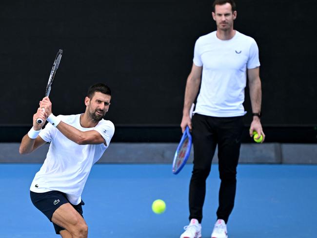 Novak Djokovic hits a return as Andy Murray looks on. Picture: William West