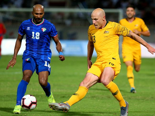 KUWAIT CITY, KUWAIT - SEPTEMBER 10: Aaron Mooy of Australia and Amer Almatoug Alfadhel of Kuwait in action during the FIFA World Cup Qatar 2022 and AFC Asian Cup China 2023 Preliminary Joint Qualification Round 2 match between Kuwait and the Australia Socceroos at Kuwait Club Stadium on September 10, 2019 in Kuwait City, Kuwait. (Photo by Tom Dulat/Getty Images)