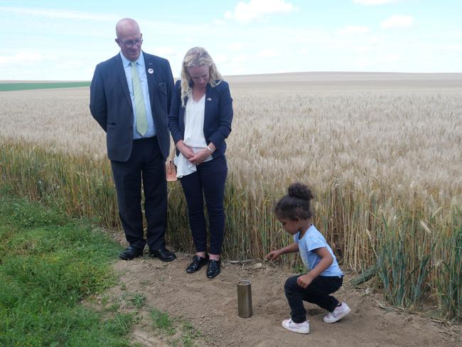 David Ridgway watches as a child from Dernancourt, France, takes soil to be sent to Dernancourt in South Australia. Picture: supplied