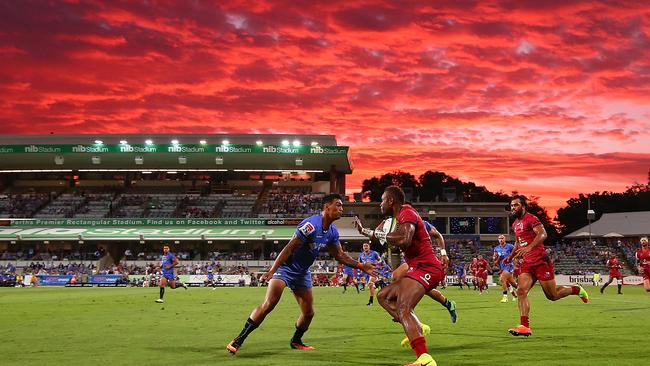 Eto Nabuli of the Reds looks to avoid being tackled by Chance Peni of the Force.