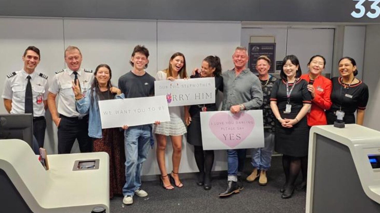 Mr Young’s kids held a sign that said: “We want you to be our evil stepmother – marry him!”. Picture: Supplied