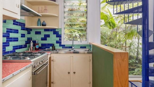 The home has a vibrant kitchen and blue spiral staircase. Picture: realestate.com.au
