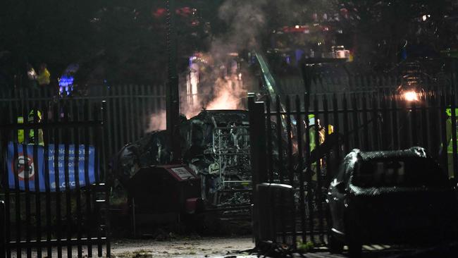 Emergency services work at the scene on the wreckage of the helicopter that crashed in a car park outside Leicester City Football Club's King Power Stadium in Leicester.