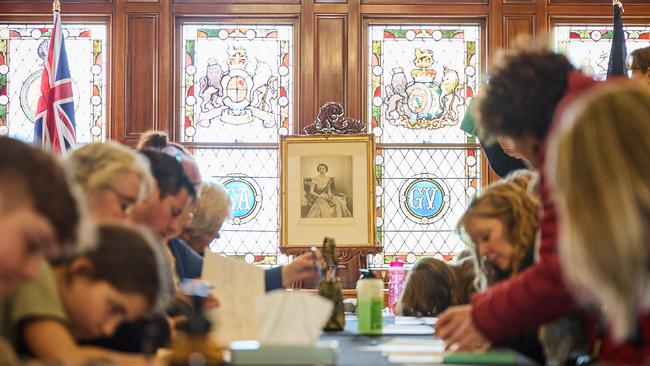 People signing condolence books at Government House, Adelaide. Picture: Matt Loxton