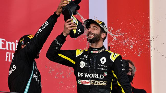 Lewis Hamilton spills champagne over Ricciardo as he performs his trademark ‘shoey’ celebration. Picture: Miguel Medina/Pool/AFP