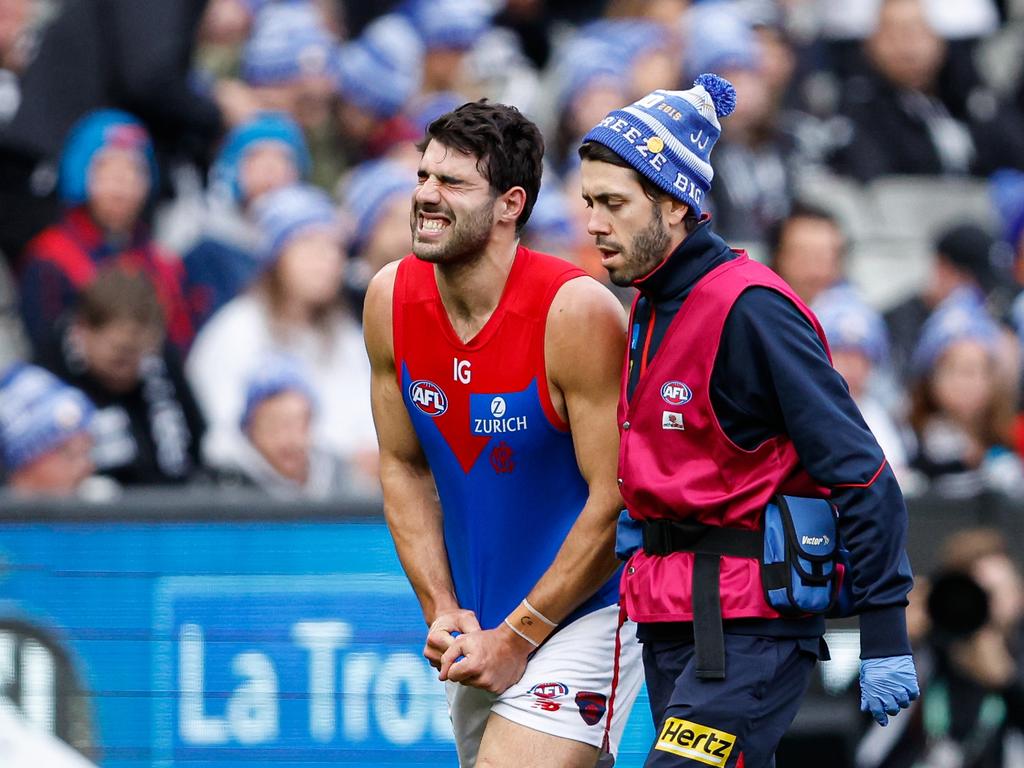 Christian Petracca leaves the MCG in pain on the King’s Birthday clash. Picture: Dylan Burns/AFL Photos via Getty Images.