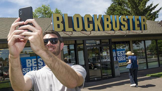 A man takes a selfie in front of the Bend, Oregon, Blockbuster store - soon to be the last of its kind in the world. Picture: AP