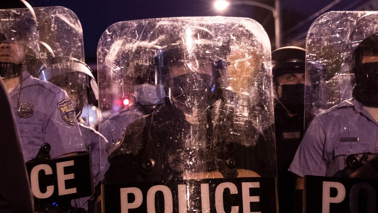 Police in riot gear face protesters marching through West Philadelphia. Picture: Gabriella Audi/AFP