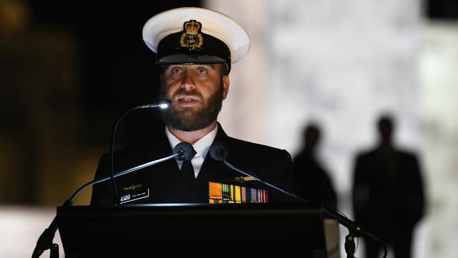 Benjamin Sime reads letters and diaries of Australians who experienced war first-hand during the dawn service at the National War Memorial in Canberra. Picture: AAP.