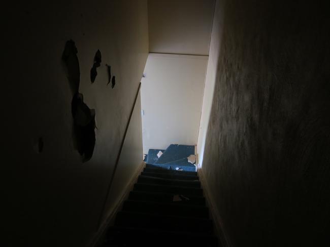 Creepy, the stairs have holes in the walls and carpet lifting from the treads. Picture: supplied