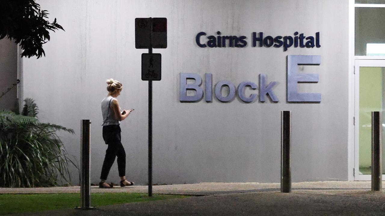 A woman walks walks past the E Block at the Cairns Hospital at night. Picture: Brendan Radke