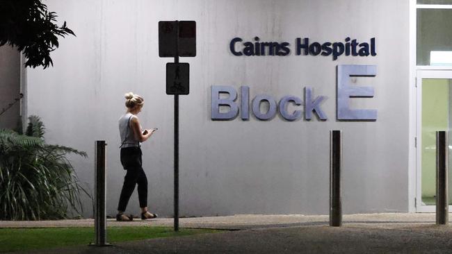A woman walks walks past the E Block at the Cairns Hospital at night. Picture: Brendan Radke