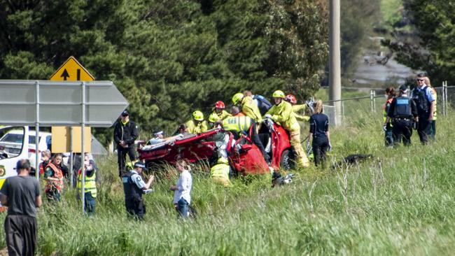 Paramedics surround the car in which three family members died. Picture: OnScene ACT