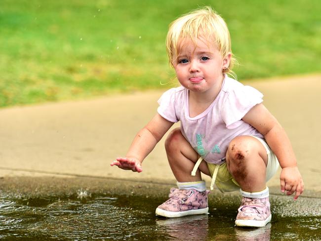 Weather Pic; Alainnah Jackson-Jones 17m from Wulguru, plays in the puddles on the Strand.