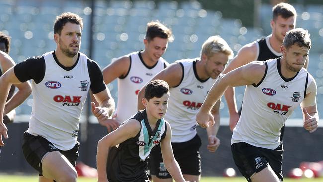 Young Ryan Lane-Ellis, 12, was the very first patient Travis Boak visited in hospital as part of his work with the Childhood Cancer Association. On Tuesday Ryan got to train with Boak at Alberton and on Sunday will run out with the team. Picture Sarah Reed