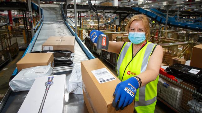 Mail officer Helen Gandolfo sorts packages in the biggest parcel delivery week in Australia Post’s 211-year history. Picture: Mark Stewart