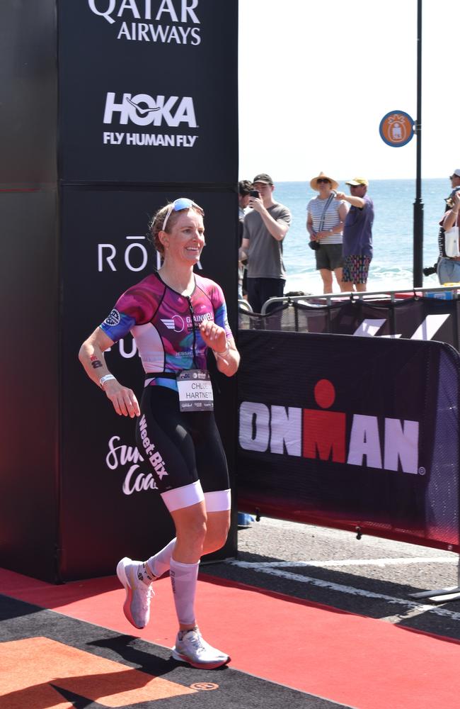 Athletes crossing the finish line at the Sunshine Coast Ironman 70.3 2023.