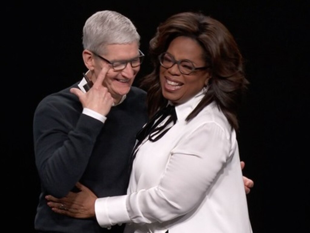 Tim Cook sheds a tear as he hugs Oprah. 