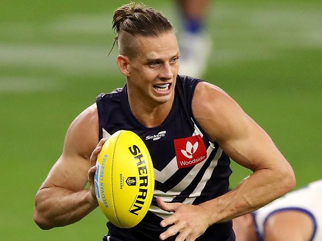 PERTH, AUSTRALIA - APRIL 24: Nat Fyfe of the Dockers runs with the ball during the 2021 AFL Round 06 match between the Fremantle Dockers and the North Melbourne Kangaroos at Optus Stadium on April 24, 2021 in Perth, Australia. (Photo by Will Russell/AFL Photos via Getty Images)