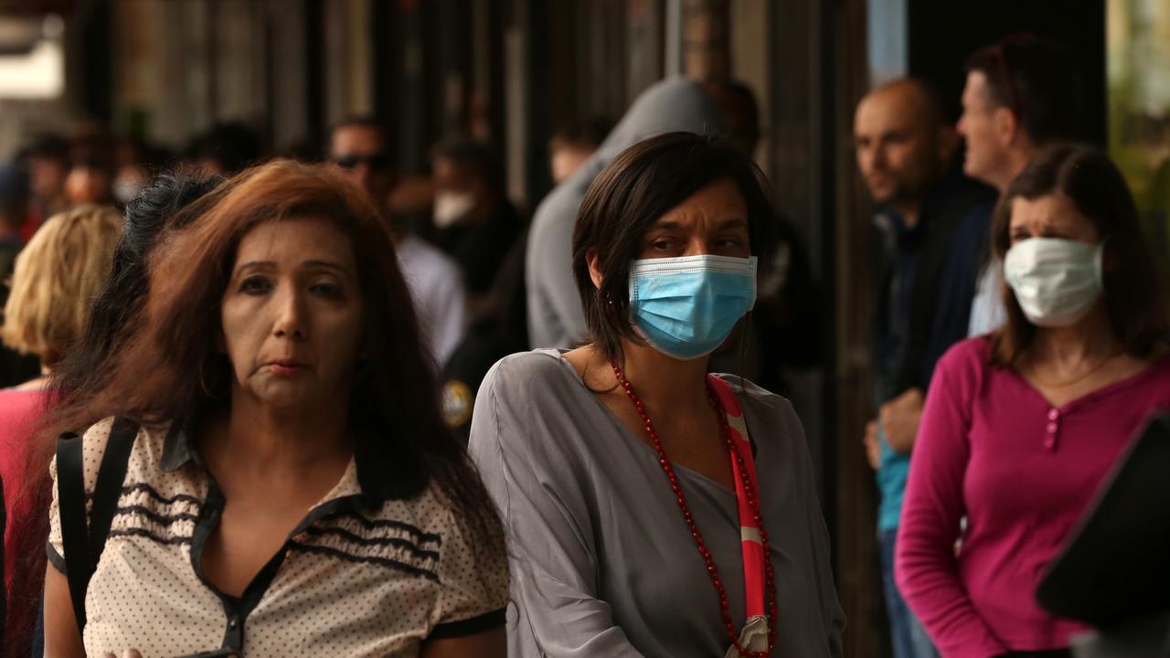 People are seen in long queues outside the Centrelink office in Marrickville, Sydney. Picture: AAP