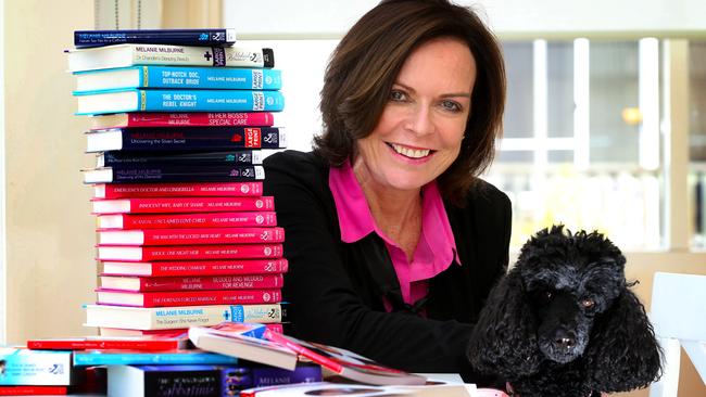 Tasmanian author Ris Wilkinson (Melanie Milburne) is about to have her 50th Mills & Boon novel published. Ris with Lilly one of her poodles and some of her 50 titles. Book number 50, and Maelanie's Tiffany pin sent from the publishers to celebrate.