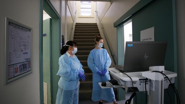 Nurse unit manager Louise Barclay and nurse Ellen Corless prepare for patient arrivals at the COVID-19 and flu assessment clinic at Prince of Wales Hospital in Sydney last May. Picture: Lisa Maree Williams/Getty Images