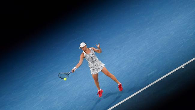 Australia's Ashleigh Barty hits a return against Danielle Collins