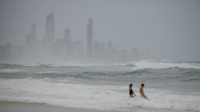 Swimmers brave the dangerous swell. Picture: Jerad Williams