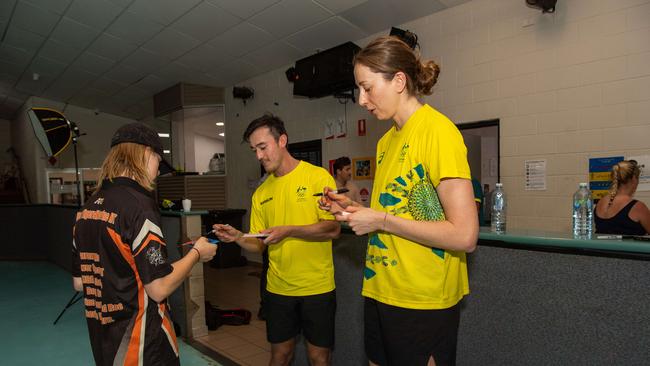 Nick Timmings and Natalia Burton signing cards for Noah Strachan as Olympians run training drills with Katherine kids at the YMCA as part of Olympics Unleashed program. Picture: Pema Tamang Pakhrin