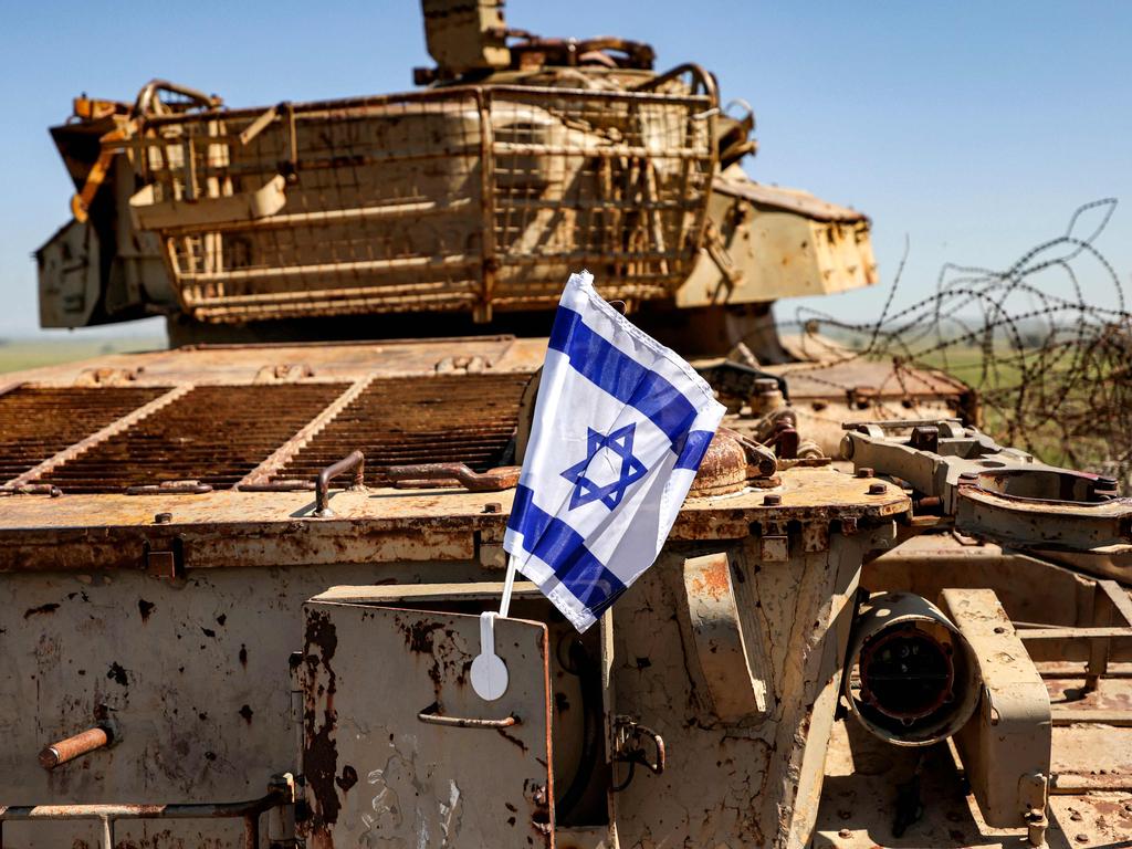 An Israeli flag hangs on the rusty remains of an Israeli battle tank at a memorial from the 1973 Arab-Israeli War on Tel Saki, a hill near the Syrian border in the Israel-annexed Golan Heights, on April 25, 2023. Picture: AFP