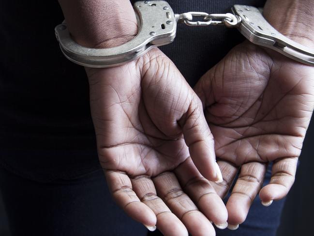 Black woman in handcuffs stock image