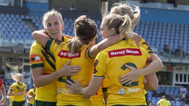 Isabelle Kelly celebrates a try with her Jillaroos teammates.