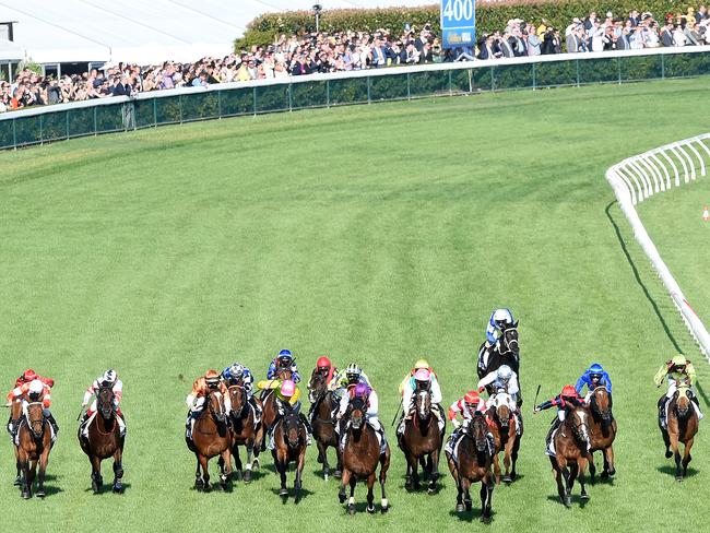 Opie Bosson (red/white) on Mongolian Khan wins the 2015 Caulfield Cup. Picture: Nicole Garmston