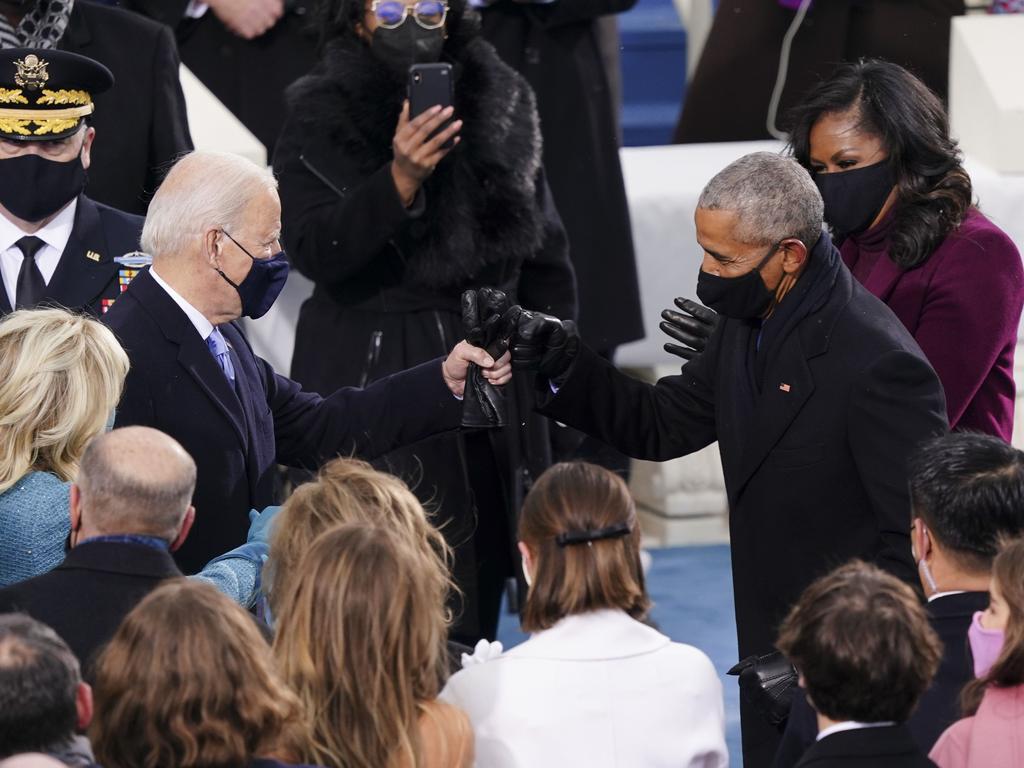 Joe Biden greets former US President Barack Obama with a fist bump. Picture: AFP