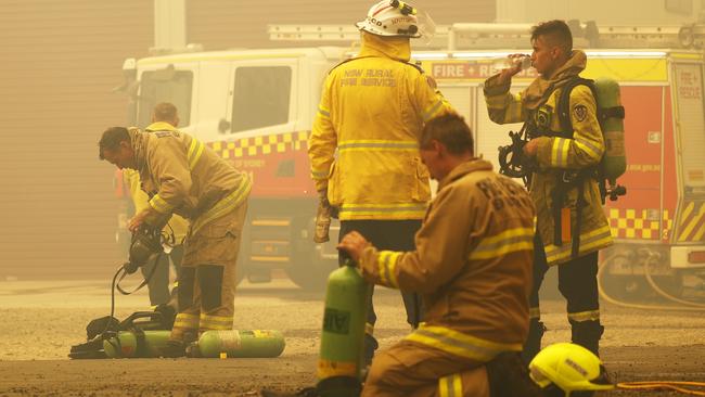 Exhausted firefighters take a break at Balmoral, south west of Sydney. Picture: Sam Ruttyn