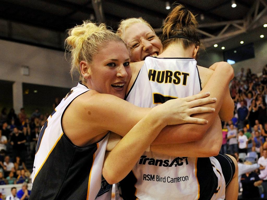 Lauren Jackson, Abby Bishop and Nat Hurst celebrate the 2010 WNBL title win.