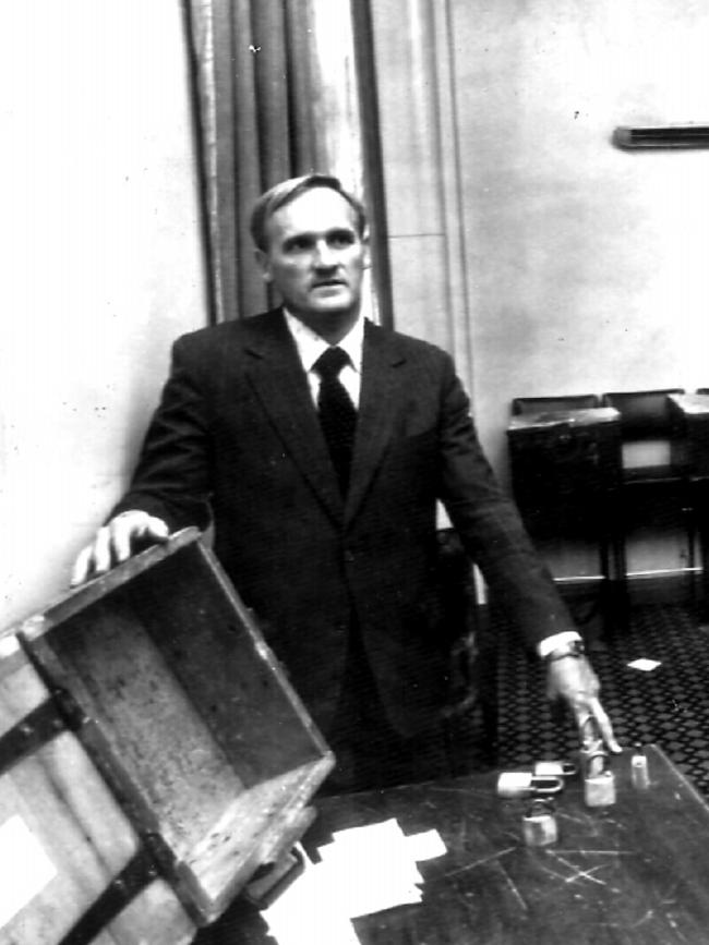 Victorian Club secretary Frank Murray with empty boxes and smashed padlocks.