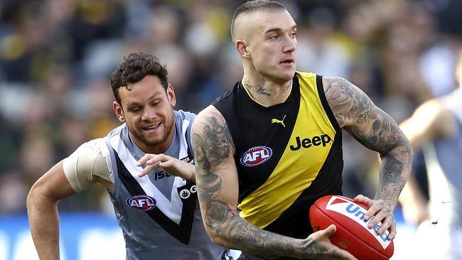 Richmond star Dustin Martin sprints away from Port Adelaide’s Steven Motlop.