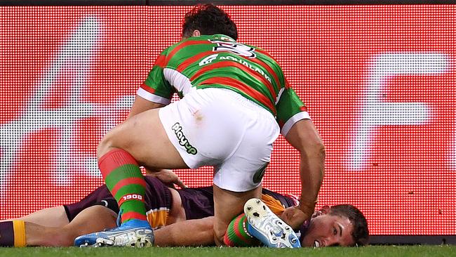 Corey Oates lays dazed on the ground after copping a James Roberts elbow to the back of the head. Picture: AAP Image/Dan Peled