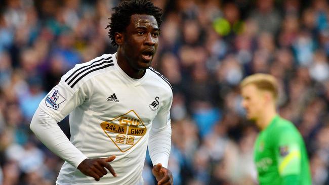 (FILES) In a file picture taken on November 22, 2014 Swansea City's Ivorian striker Wilfried Bony celebrates scoring the opening goal during the English Premier League football match between Manchester City and Swansea City at the The Etihad Stadium in Manchester, north west England. Swansea striker Wilfried Bony signed for English Premier League champions Manchester City, the Ivory Coast football federation announced, on January 14, 2015. The fee is believed to be about 28 million pounds ($42 million, 36 million euros). AFP PHOTO/PAUL ELLIS RESTRICTED TO EDITORIAL USE. NO USE WITH UNAUTHORIZED AUDIO, VIDEO, DATA, FIXTURE LISTS, CLUB/LEAGUE LOGOS OR “LIVE” SERVICES. ONLINE IN-MATCH USE LIMITED TO 45 IMAGES, NO VIDEO EMULATION. NO USE IN BETTING, GAMES OR SINGLE CLUB/LEAGUE/PLAYER PUBLICATIONS.