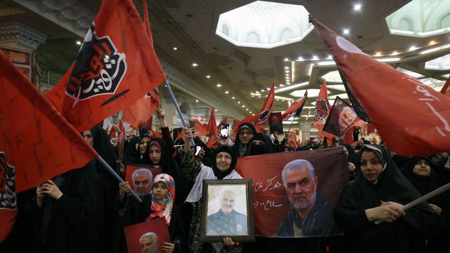 Iranians hold portraits of slain top Iranian commander Qasem Soleimani during the commemoration ceremony marking the anniversary of his killing in Tehran on Wednesday. Picture: AFP