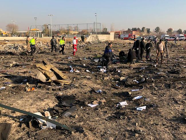 People and rescue teams are pictured amid the wreckage after a Ukrainian plane carrying 176 people crashed near Imam Khomeini airport in the Iranian capital Tehran. Picture: AFP