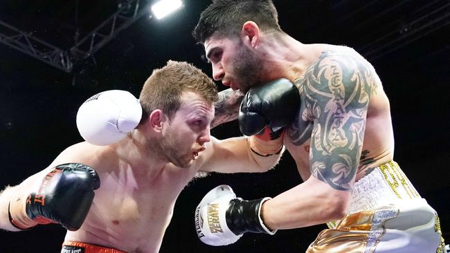 Jeff Horn (left) and Michael Zerafa trade blows on Saturday night. Picture: AAP