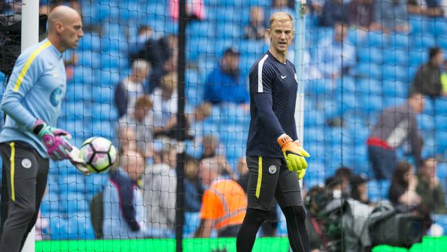 Manchester City's Joe Hart, right, watches teammate Wilfredo Caballero.