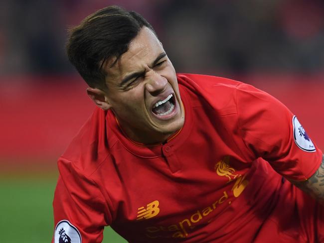 Liverpool's Brazilian midfielder Philippe Coutinho holds his foot as he lies on the pitch injured during the English Premier League football match between Liverpool and Sunderland at Anfield in Liverpool, north west England on November 26, 2016. / AFP PHOTO / Paul ELLIS / RESTRICTED TO EDITORIAL USE. No use with unauthorized audio, video, data, fixture lists, club/league logos or 'live' services. Online in-match use limited to 75 images, no video emulation. No use in betting, games or single club/league/player publications. /