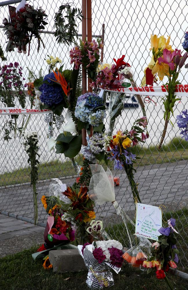 Floral tributes are placed on a security fence on the Whakatane Wharf. Picture: Getty