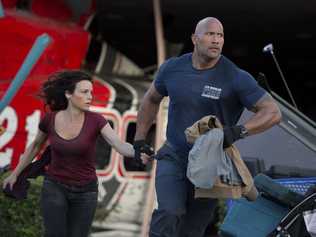 ON THE MOVE: Carla Gugino and Dwayne 'The Rock' Johnson in a scene from the movie San Andreas. Jasin Boland. Picture: Jasin Boland