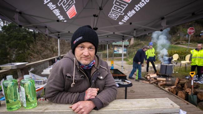 Luke Pedley set up a barbecue and gazebo for the community after the storm. Picture: Jason Edwards