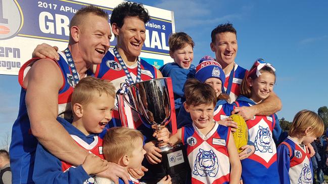 (From left) cousin Blair Harvey, Shane Harvey and Brent Harvey celebrate North Heidelberg’s 2017 Division 2 premiership. Picture: Tim Michell